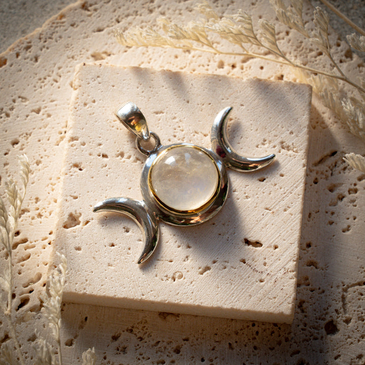 Handcrafted Moonstone Triple Moon Pendant in sterling silver with 24k gold highlights. A sacred symbol of intuition, feminine energy and new beginnings. One of StoneAge's timeless designs.